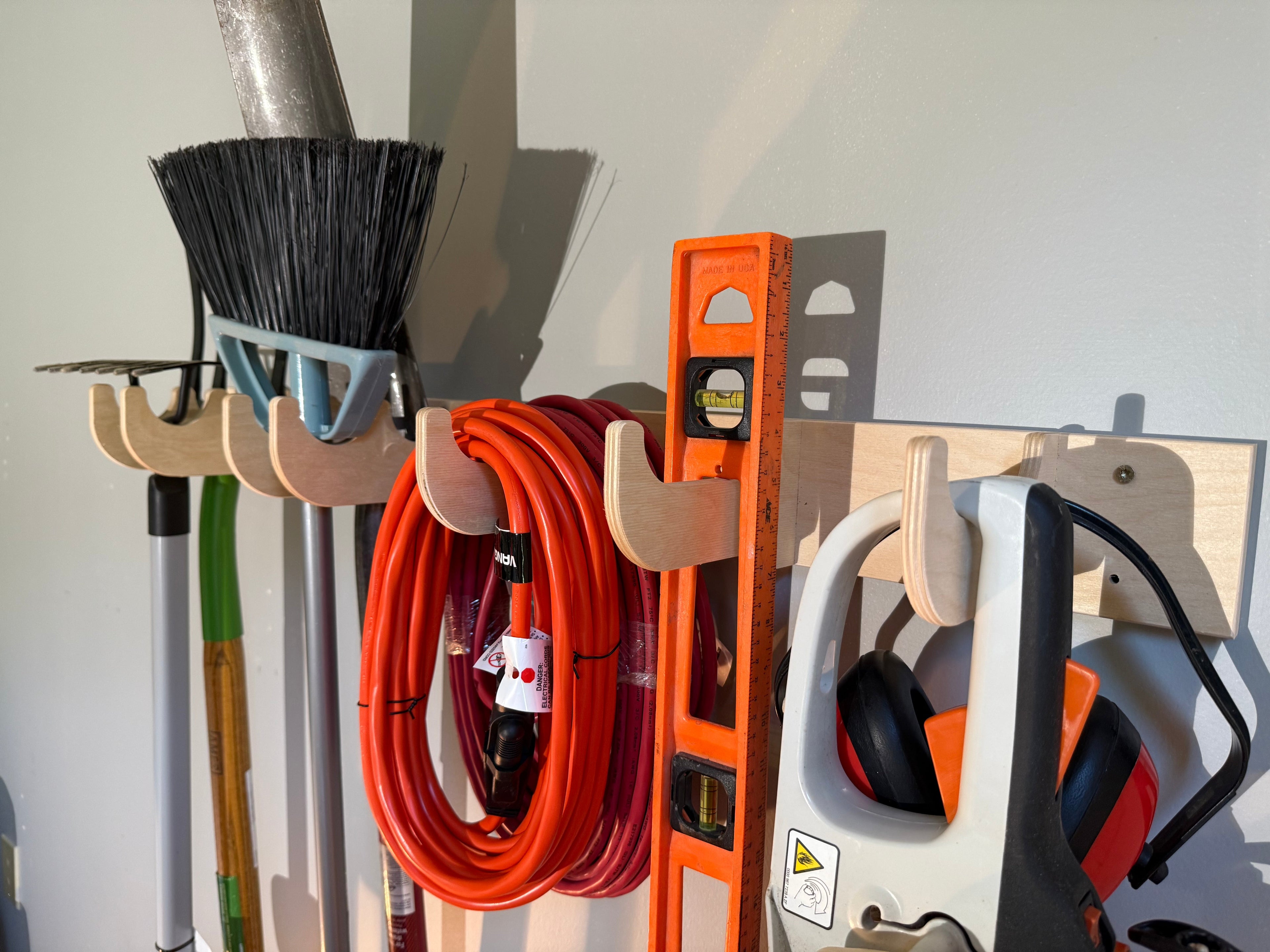 Garage Organization device for shovels and rakes in Garage spaces. Yard tool rack for garage.