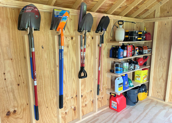 A nicely organized shed with shelving and yard tool racks. www.hangthisup.com offers simple to use and install yard tool racks.