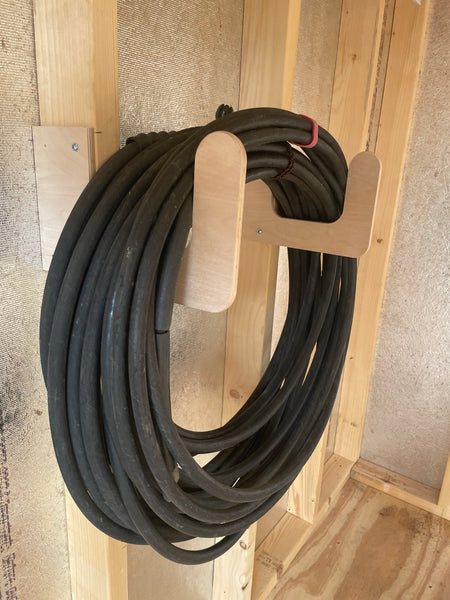 Garden hose organizer rack in a shed with 2x4" studs.  Simple install.