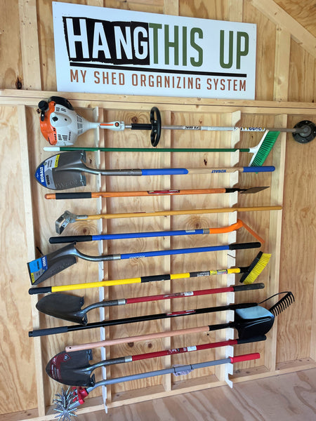 1. Wall mounted tool rack with various tools, perfect for organizing garden and yard tools in a wood shed. 2. Tool rack for shed storage, featuring a variety of garden and yard tools on a wall mount. 3. Organize your shed with this wall mounted tool rack, ideal for storing garden tools and yard equipment.