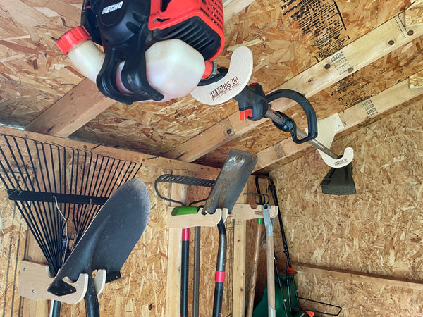 Ceiling mounted Weed Wacker rack in a storage shed.