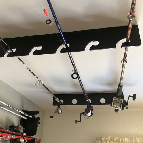 A wooden fishing rod rack hanging from the ceiling, providing storage for fishing rods in a garage space.