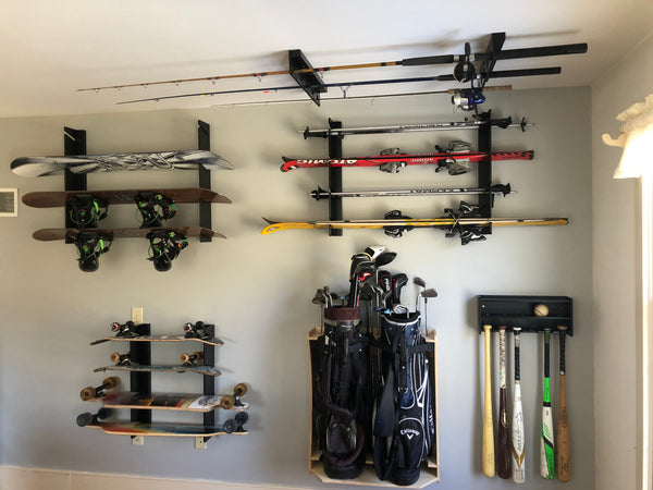 A wooden fishing rod rack hanging from the ceiling, providing storage for fishing rods in a garage space.