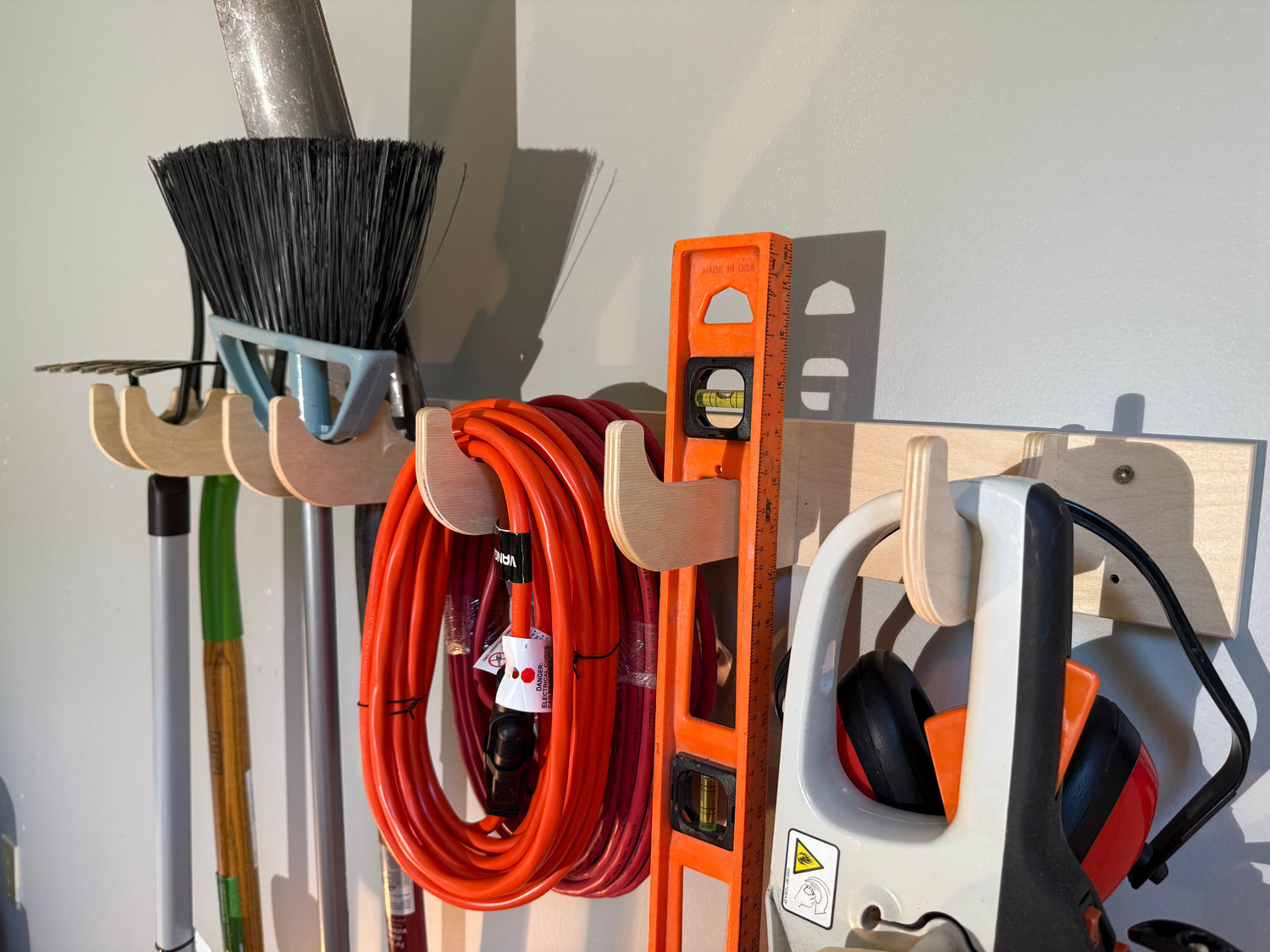 Garage Organization device for shovels and rakes in Garage spaces. Yard tool rack for garage.