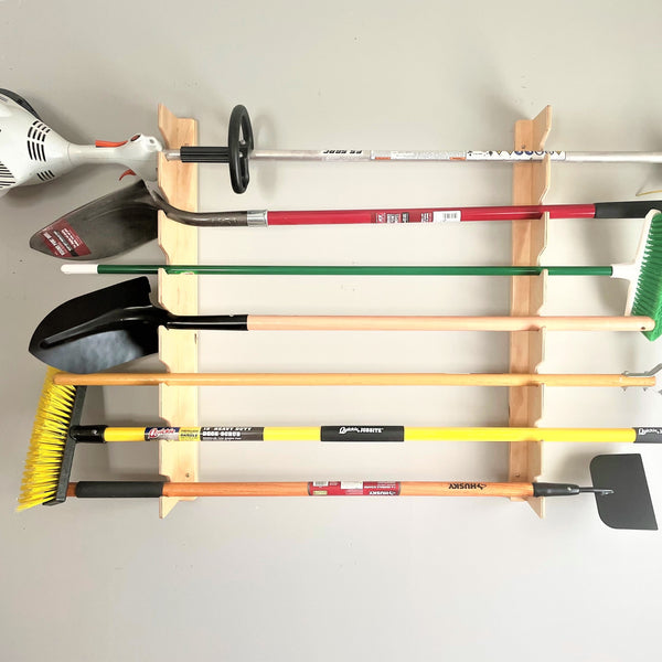 Garden tool rack for garage storage space, providing organized storage for yard tools in the garage.