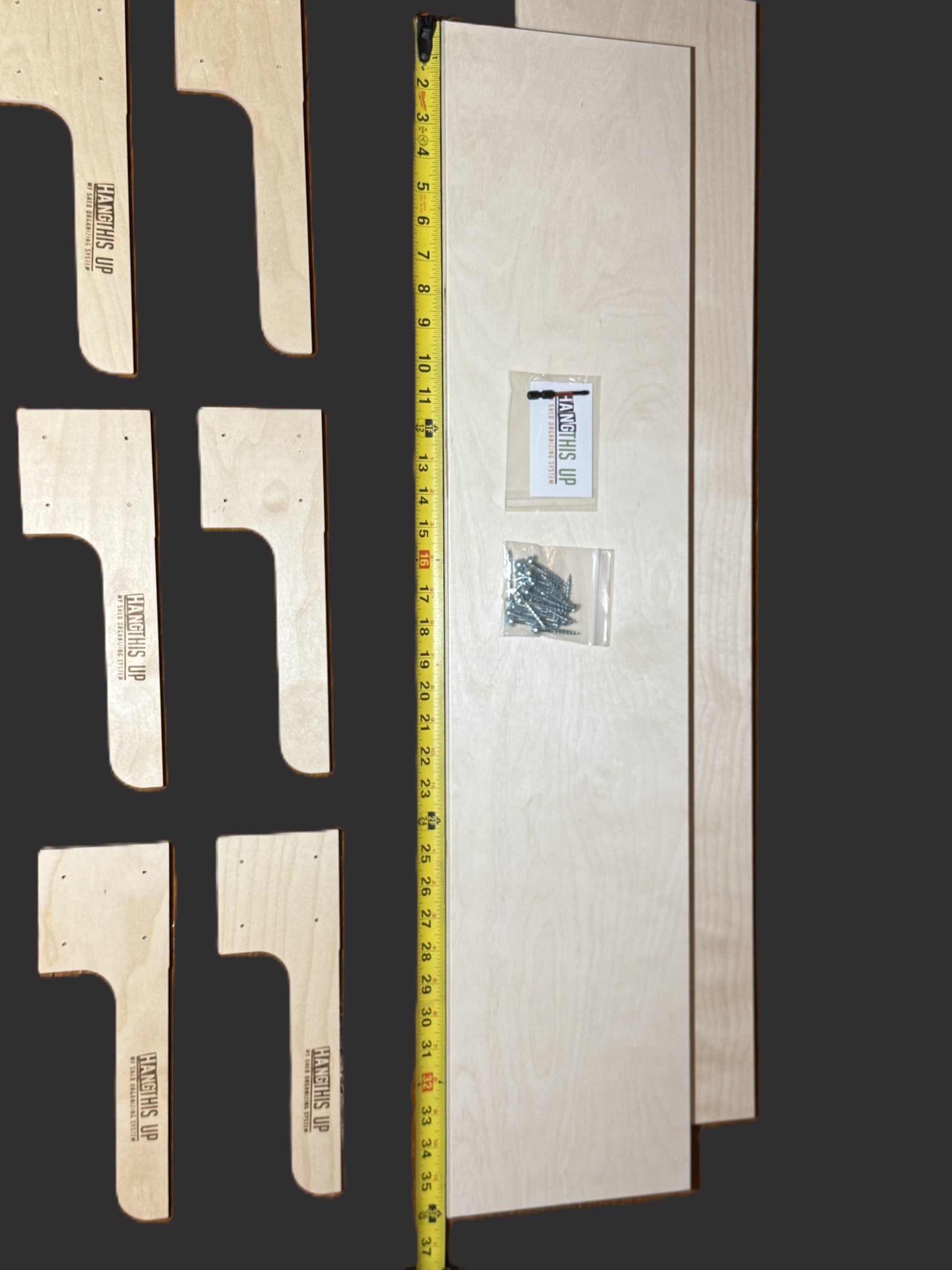 Wooden brackets with a measuring tape for scale on a dark background