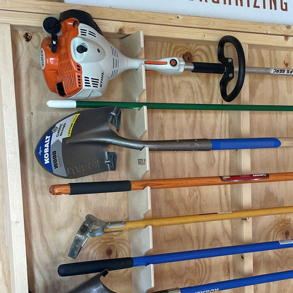 Garden tool rack for shed organization, keeping yard tools neatly stored and easily accessible.