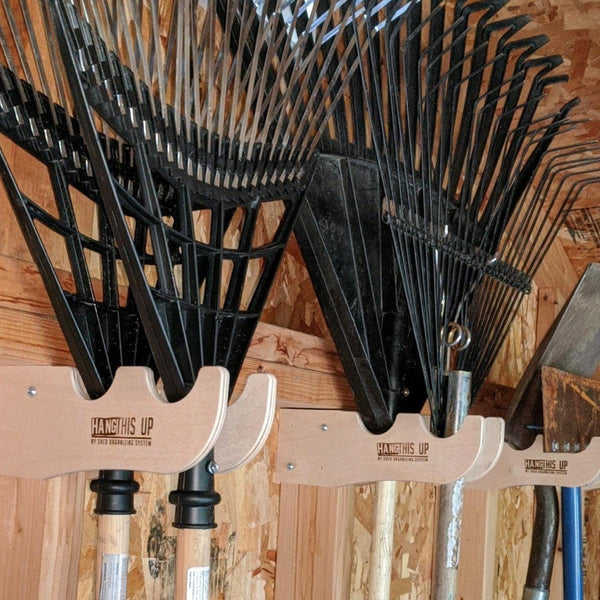 Garden yard tool rack for shed storage, keeping outdoor tools neatly organized and accessible.