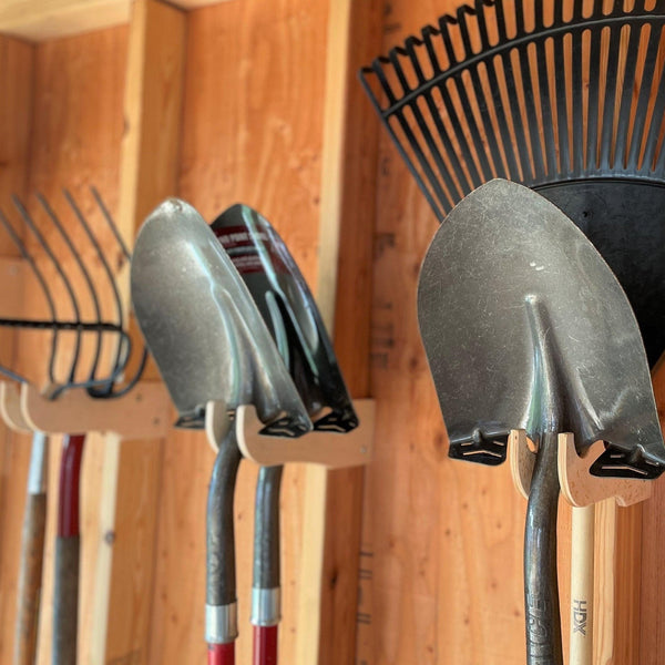 Garden yard tool rack for shed storage, keeping outdoor tools organized and easily accessible.