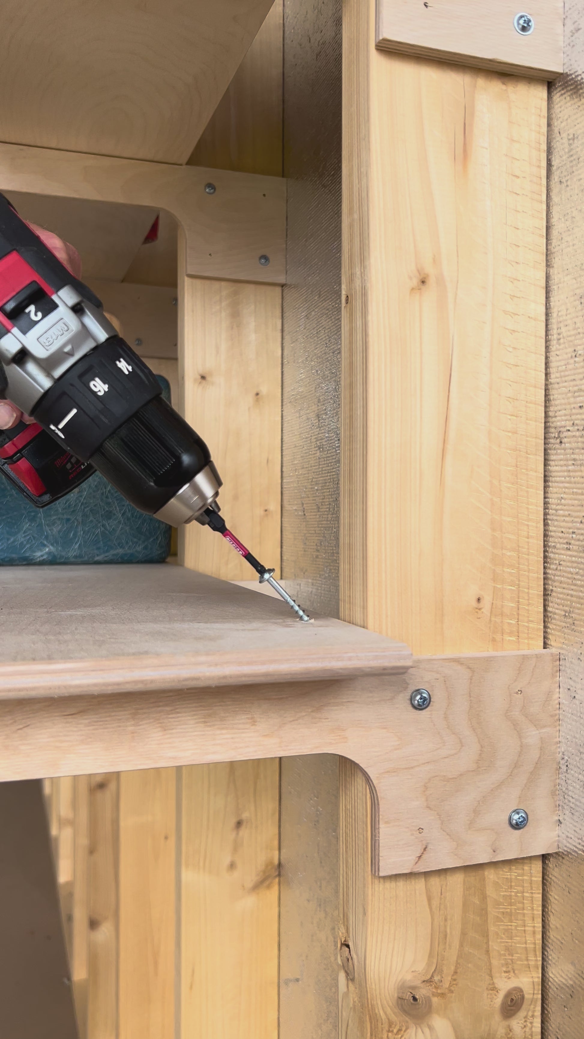 Fastening shelf to stud in a storage shed.
