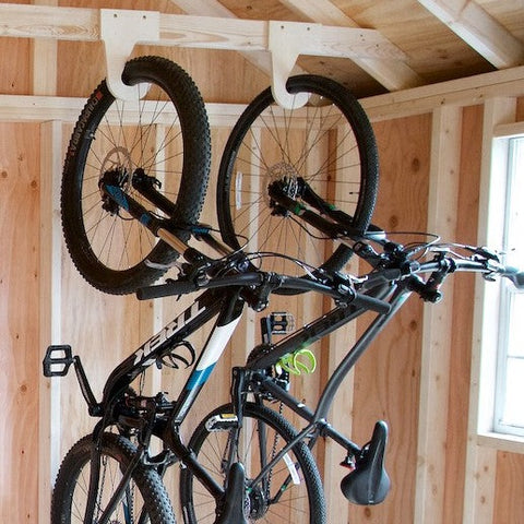 Two bikes hanging using the My S.O.S. bike organizers hanging by front wheel  