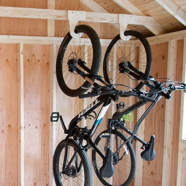 Image showing ski equipment being hung next to 2 hanging bikes 
