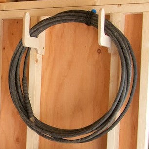 2 hoses hanging from hose organizers 