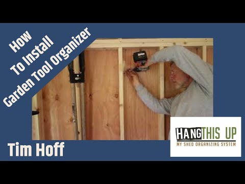 A neatly organized shed with a shelf holding tools and other items. Utilize shed organizer kit, shelf brackets, and yard tool hooks for efficient storage.